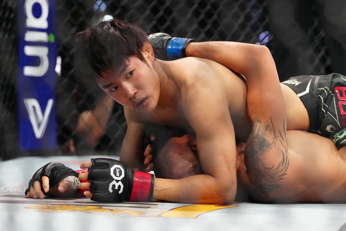Jul 8, 2023; Las Vegas, Nevada, USA; Tatsuro Taira (red gloves) fights Edgar Chairez (blue gloves) during UFC 290 at T-Mobile Arena. Mandatory Credit: Stephen R. Sylvanie-Imagn Images