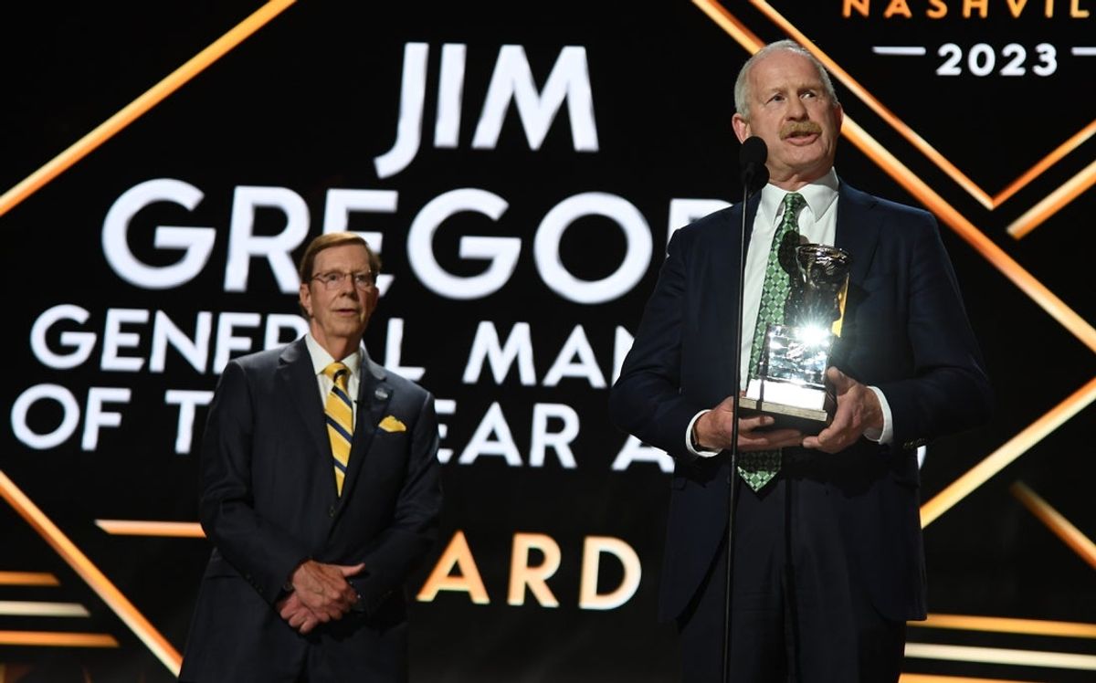 Jun 28, 2023; Nashville, Tennessee, USA; Dallas Stars general manager Jim Nill is awarded the Jim Gregory General Manager of the Year award by Nashville Predators general manager David Poile during the first round of the 2023 NHL Draft at Bridgestone Arena. Mandatory Credit: Christopher Hanewinckel-Imagn Images