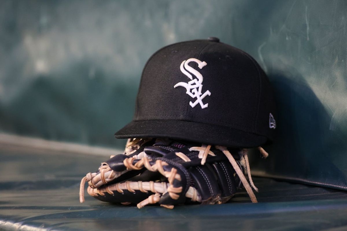 Jul 14, 2023; Atlanta, Georgia, USA; A detailed view of a Chicago White Sox hat and glove in the dugout against the Atlanta Braves in the fourth inning at Truist Park. Mandatory Credit: Brett Davis-Imagn Images