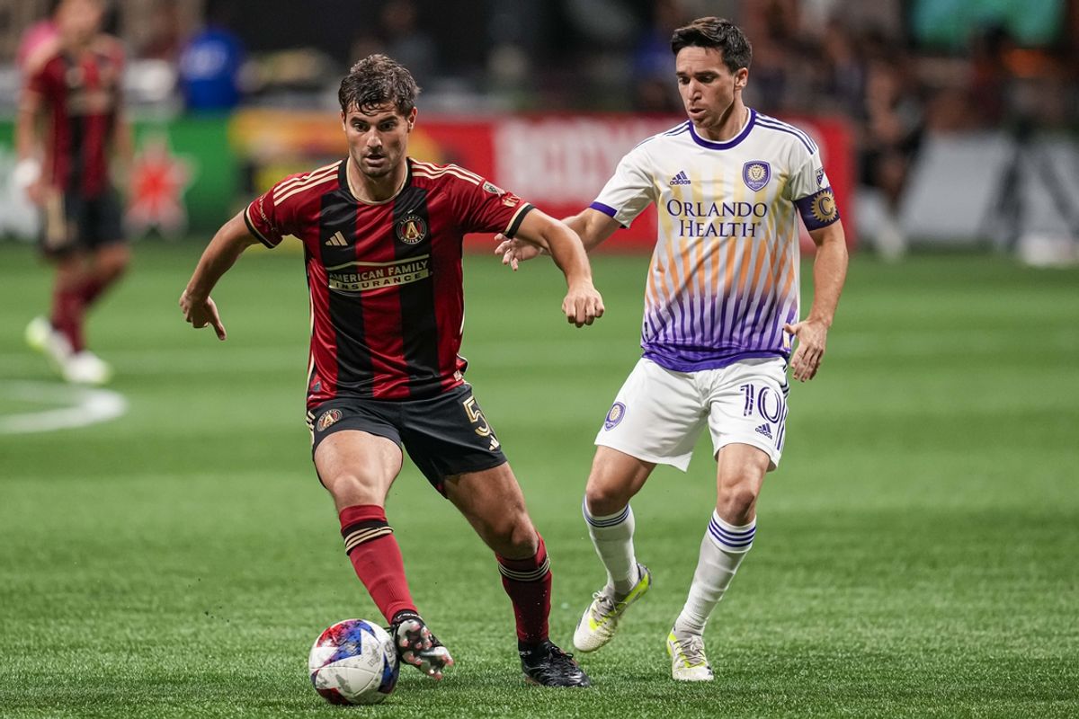 Jul 15, 2023; Atlanta, Georgia, USA; Atlanta United midfielder Santiago Sosa (5) plays the ball against Orlando City midfielder Mauricio Pereyra (10) during the first half at Mercedes-Benz Stadium. Mandatory Credit: Dale Zanine-Imagn Images