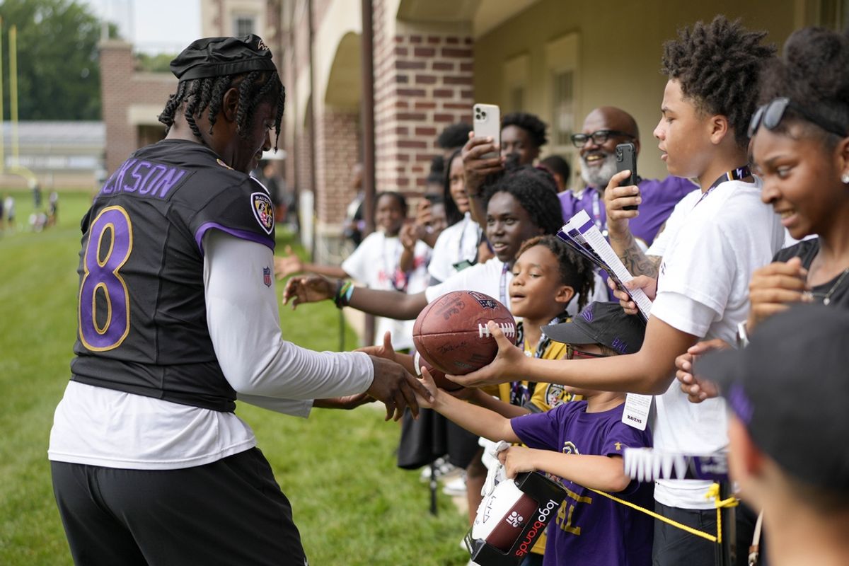 Jul 27, 2023; Owings Mills, MD, USA; Baltimore Ravens quarterback Lamar Jackson (8) greets fans after training camp practice at Under Armour Performance Center. Mandatory Credit: Brent Skeen-USA TODAY Sports