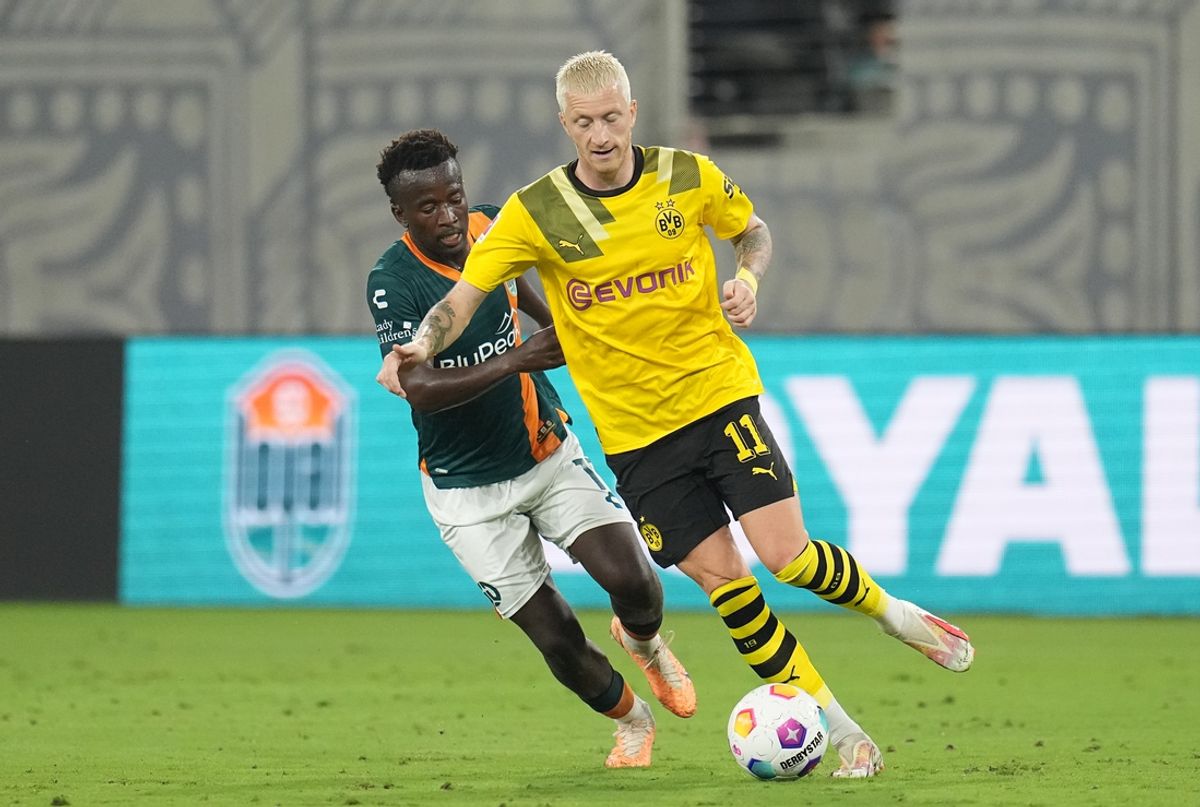 Jul 27, 2023; San Diego, California, USA; Borussia Dortmund midfielder Marco Reus (11) dribbles the ball against San Diego Loyal forward Tumi Moshobane (11) during the second half at Snapdragon Stadium. Mandatory Credit: Ray Acevedo-USA TODAY Sports