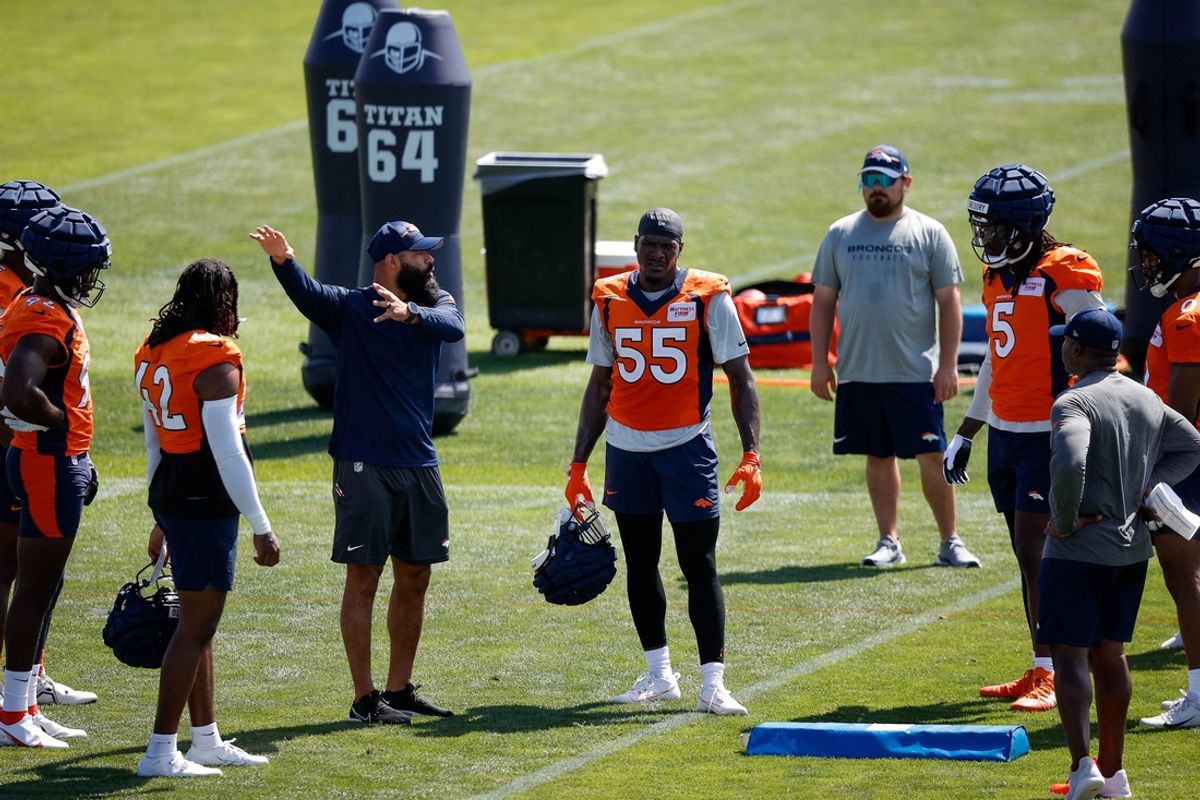 Jul 28, 2023; Englewood, CO, USA; Denver Broncos outside linebackers coach Michael Wilhoite talks with linebacker Nik Bonitto (42) and linebacker Frank Clark (55) and linebacker Randy Gregory (5) during training camp at Centura Health Training Center. Mandatory Credit: Isaiah J. Downing-Imagn Images