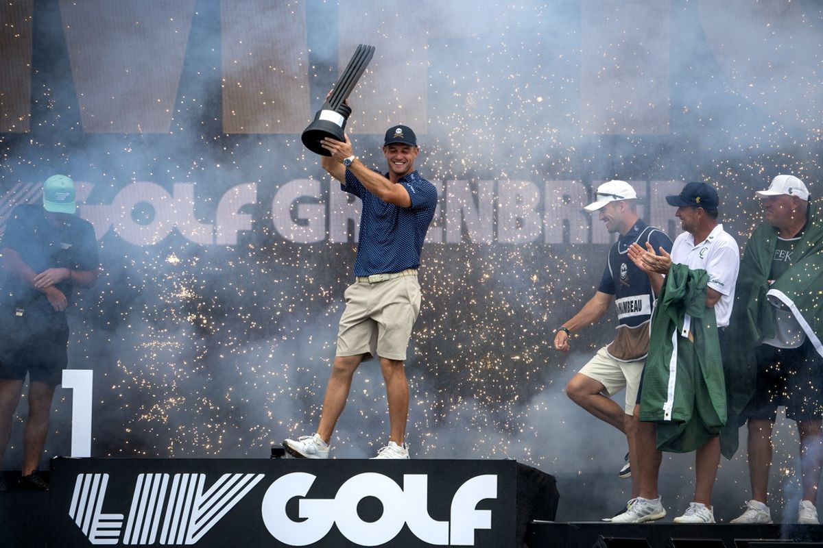 Aug 6, 2023; White Sulphur Springs, West Virginia, USA; Bryson DeChambeau celebrates with the trophy after winning the tournament during the final round of the LIV Golf event at The Old White Course. Mandatory Credit: Bob Donnan-USA TODAY Sports