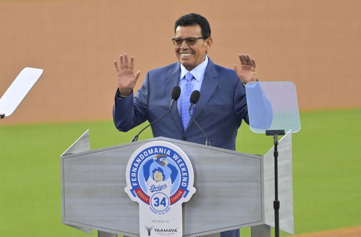 Aug 11, 2023; Los Angeles, California, USA;  Los Angeles Dodgers pitcher Fernando Valenzuela (34) speaks during a ceremony to retire his jersey number prior to a game against the Colorado Rockies at Dodger Stadium. Mandatory Credit: Jayne Kamin-Oncea-Imagn Images