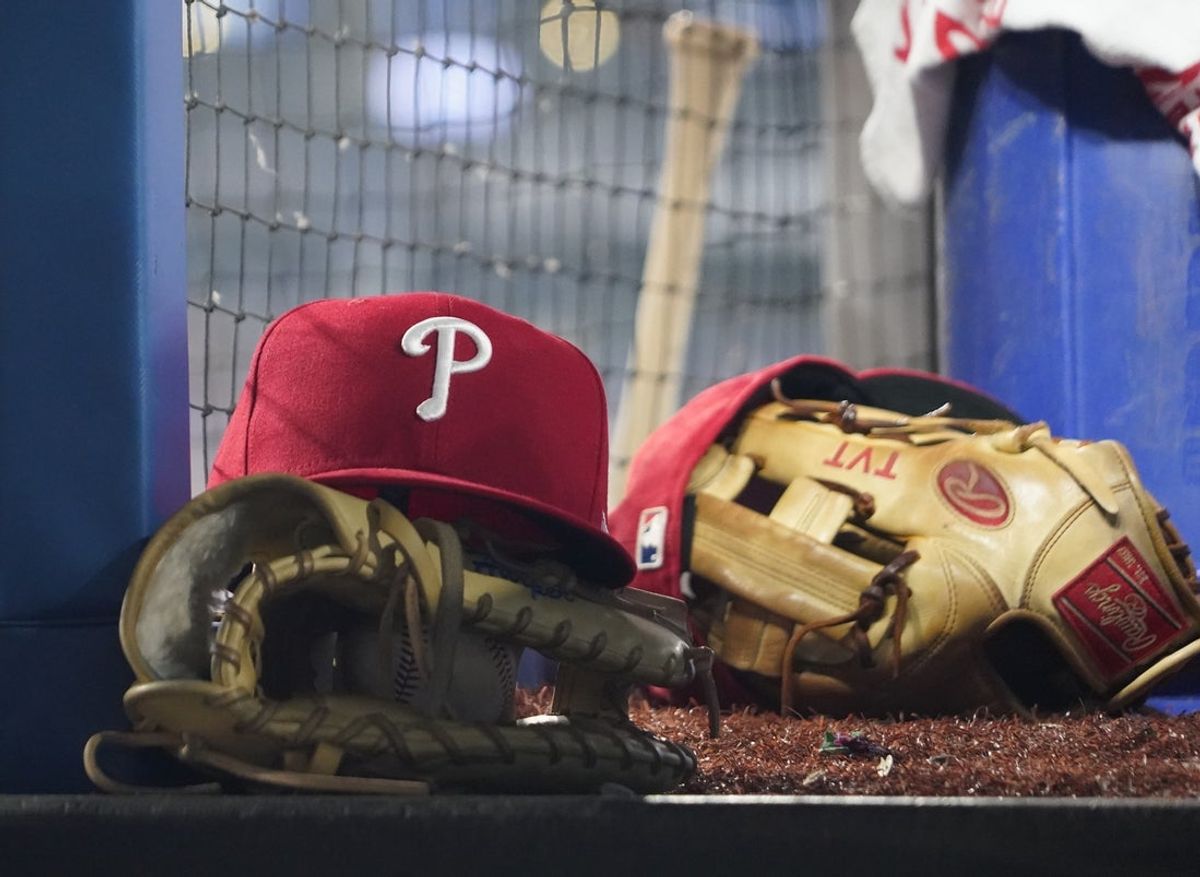 Aug 16, 2023; Toronto, Ontario, CAN; A Philadelphia Phillies cap and glove sit in the dugout during a game against the Toronto Blue Jays at Rogers Centre. Mandatory Credit: John E. Sokolowski-Imagn Images
