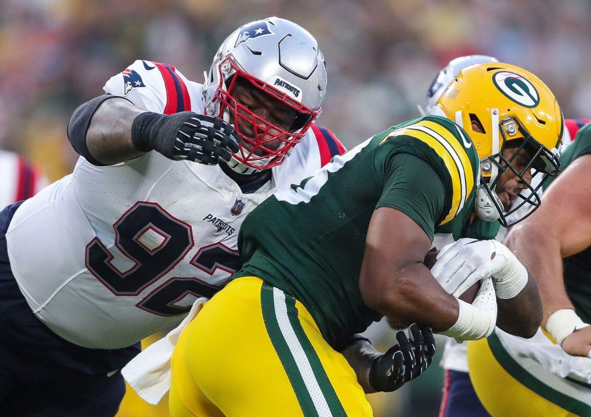 New England Patriots defensive tackle Davon Godchaux (92) tackles Green Bay Packers running back AJ Dillon (28) during their preseason football game Saturday, August 19, 2023, at Lambeau Field in Green Bay, Wis.
Tork Mason/USA TODAY NETWORK-Wisconsin