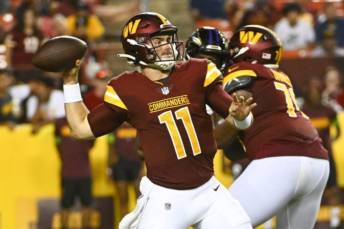 Aug 21, 2023; Landover, Maryland, USA; Washington Commanders quarterback Jake Fromm (11) drops back to pass against the Baltimore Ravens during the second half at FedExField. Mandatory Credit: Brad Mills-USA TODAY Sports