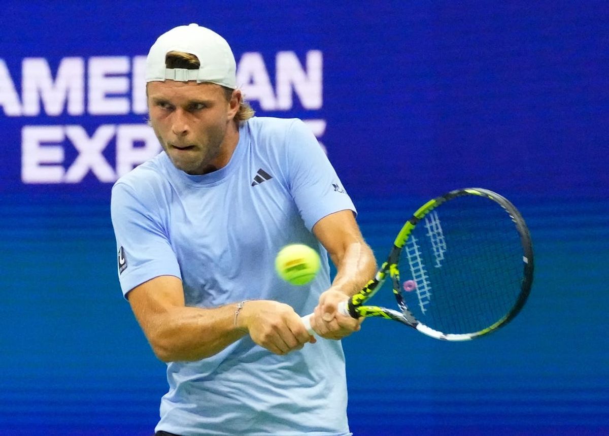 Aug 28, 2023; Flushing, NY, USA;  Alexandre Muller of France hits to Novak Djokovic of Serbia on day one of the 2023 U.S. Open tennis tournament at USTA Billie Jean King National Tennis Center.Mandatory Credit: Robert Deutsch-USA TODAY Sports