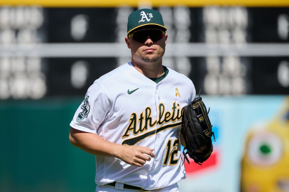 Sep 3, 2023; Oakland, California, USA; Oakland Athletics infielder Aledmys Diaz (12) returns to the dugout after the last out of the sixth inning against the Los Angeles Angels at Oakland-Alameda County Coliseum. Mandatory Credit: Robert Edwards-USA TODAY Sports