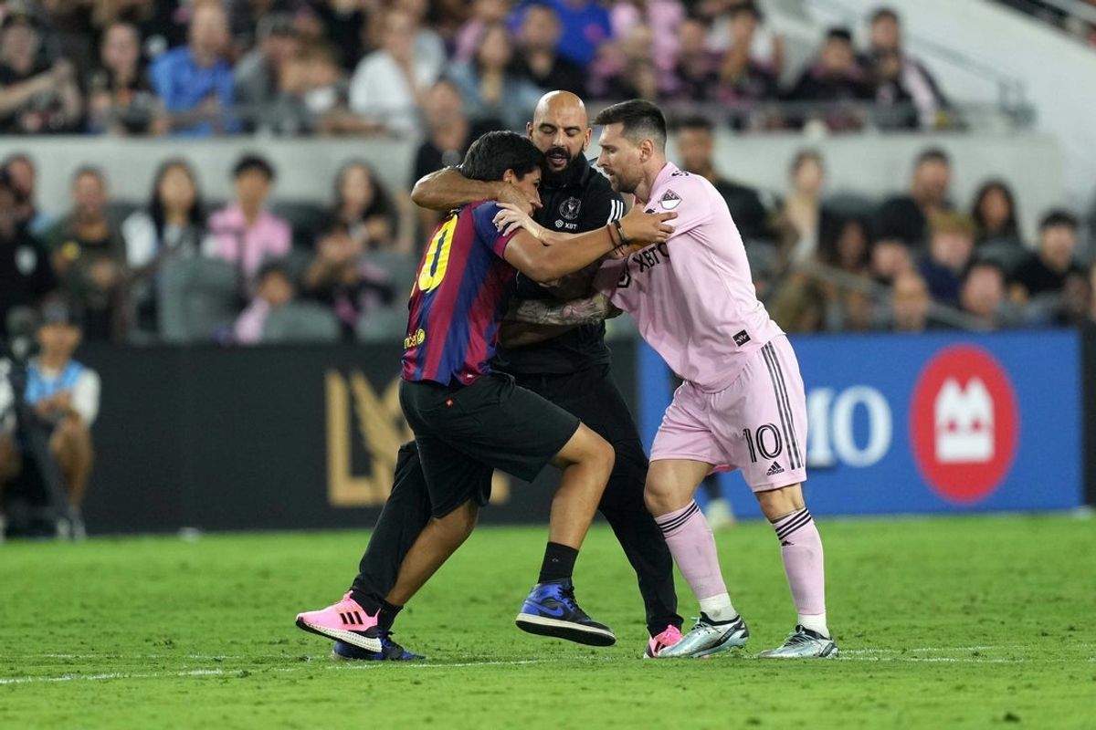 Sep 3, 2023; Los Angeles, California, USA; A fan approaches Inter Miami CF forward Lionel Messi (10) as personal security guard Yassine Cheuko intervenes during the game against LAFC at BMO Stadium. Mandatory Credit: Kirby Lee-Imagn Images