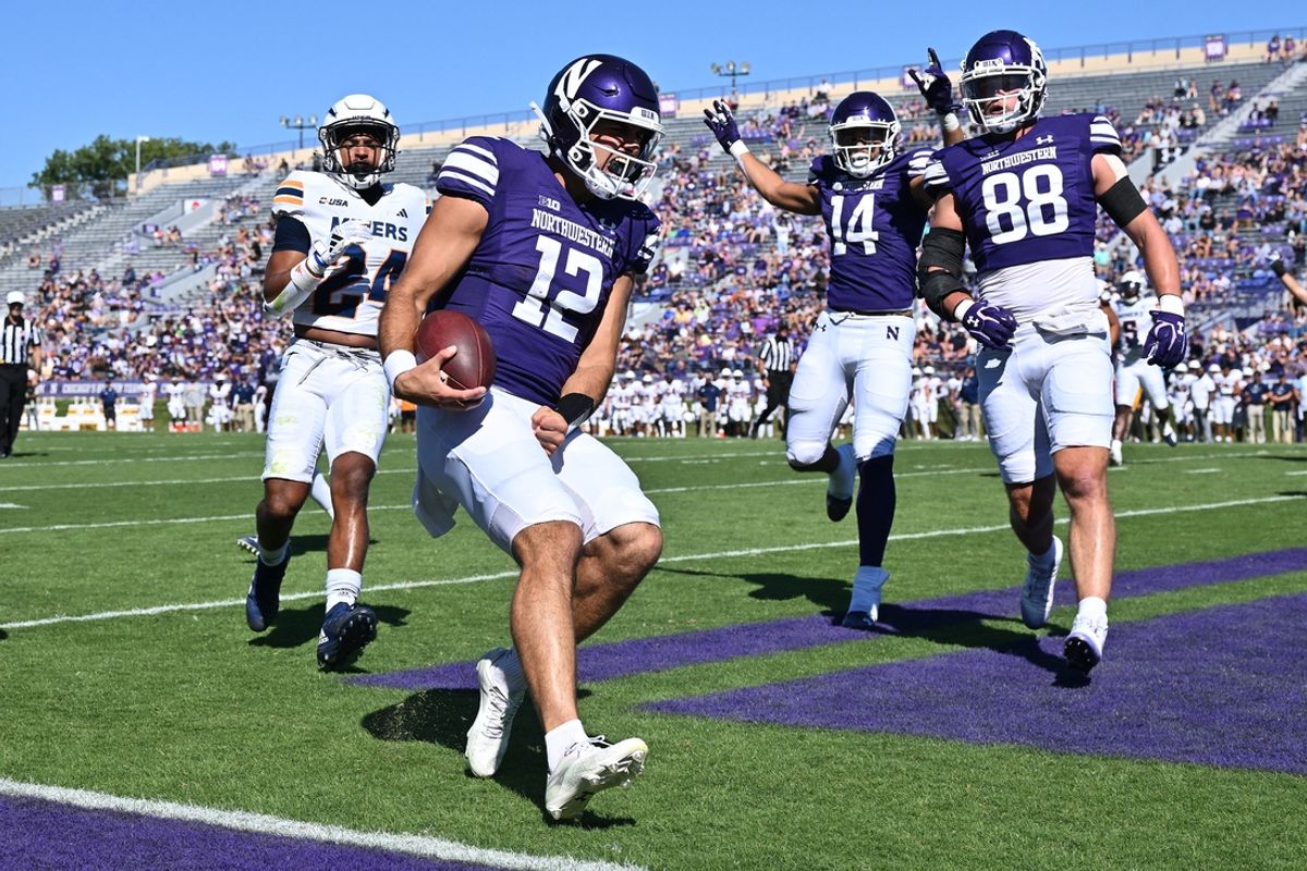 Sep 9, 2023; Evanston, Illinois, USA;  Northwestern Wildcats quarterback Jack Lausch (12) celebrates after scoring a touchdown in the first half against the University of Texas El Paso Miners at Ryan Field. Mandatory Credit: Jamie Sabau-Imagn Images