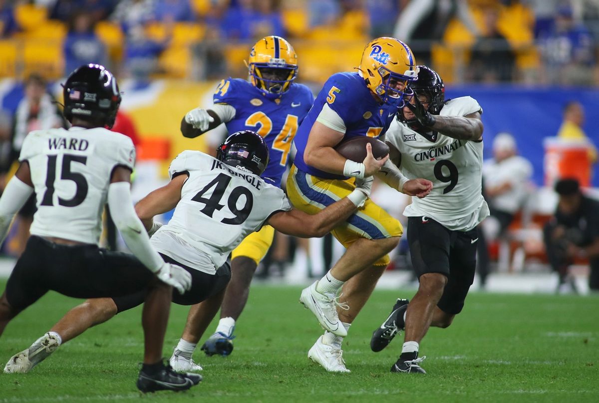 Pittsburgh Panthers Phil Jurkovec (5) gets wrapped up by Cincinnati Bearcats Jack Dingle (49) and Daniel Grzesiak (9) during the second half at Acrisure Stadium in Pittsburgh, PA on September 9, 2023