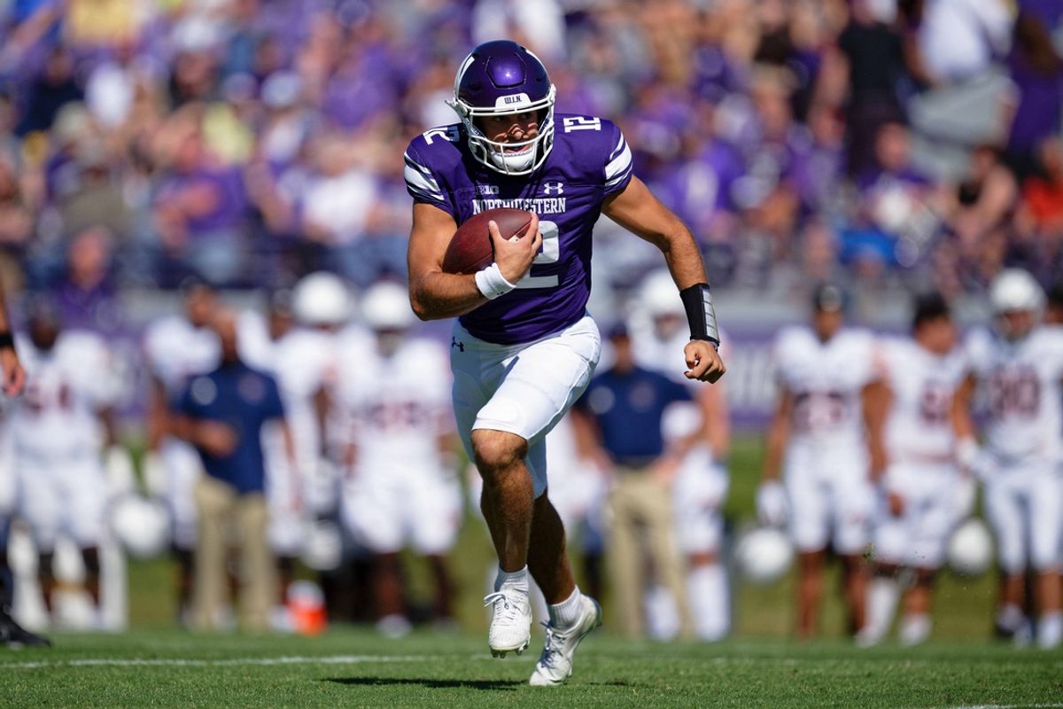 Sep 9, 2023; Evanston, Illinois, USA;  Northwestern Wildcats quarterback Jack Lausch (12) carries the ball against the University of Texas El Paso Miners at Ryan Field. Mandatory Credit: Jamie Sabau-Imagn Images