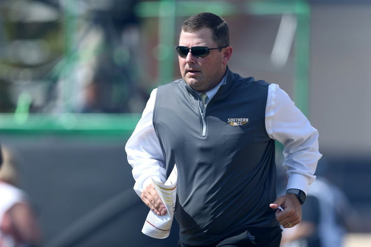 Sep 16, 2023; Hattiesburg, Mississippi, USA; Southern Miss Golden Eagles head coach Will Hall runs onto the field before their game against the Tulane Green Wave at M.M. Roberts Stadium. Mandatory Credit: Chuck Cook-Imagn Images