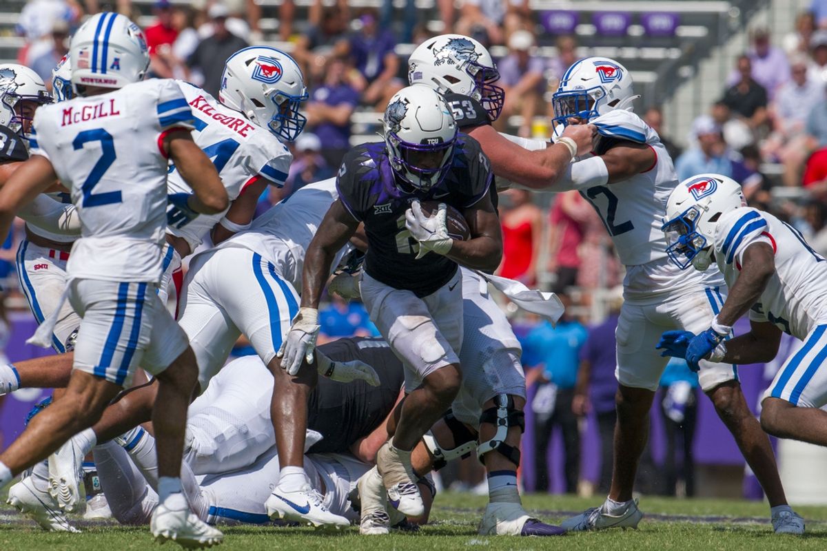 Sep 23, 2023; Fort Worth, Texas, USA; TCU Horned Frogs running back Trey Sanders (2) runs through the SMU Mustangs defensive line during the second half at Amon G. Carter Stadium. Mandatory Credit: Jerome Miron-Imagn Images