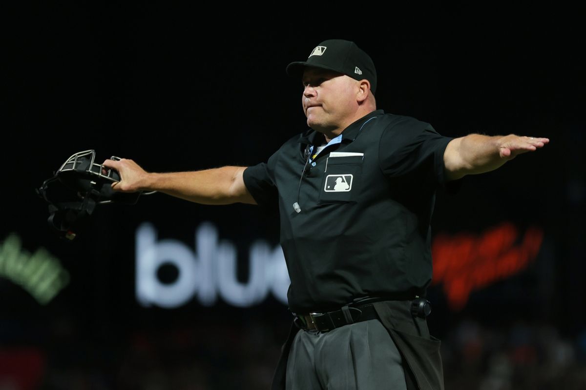 Sep 25, 2023; San Francisco, California, USA; umpire Mark Carlson (6) calls San Diego Padres right fielder Fernando Tatis Jr. (not pictured) safe at first base during the sixth inning against the San Francisco Giants at Oracle Park. Mandatory Credit: Sergio Estrada-Imagn Images