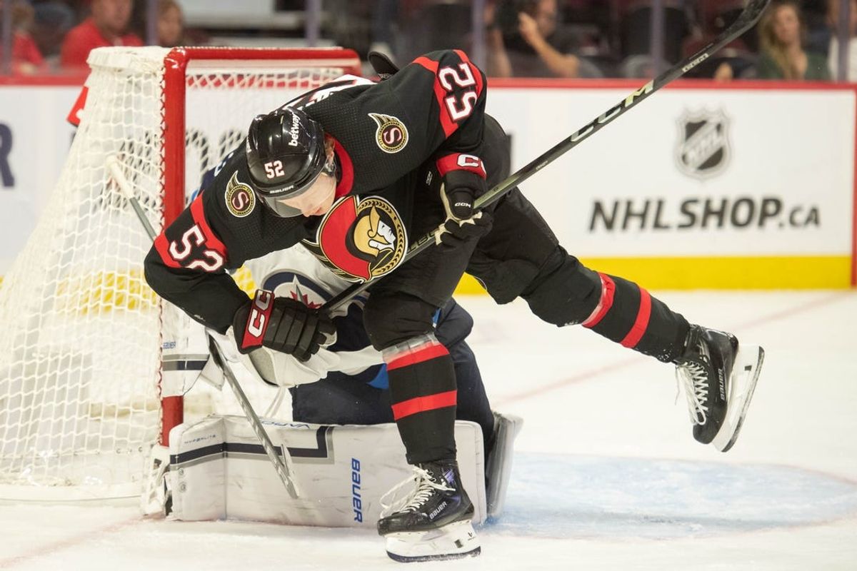 Sep 29, 2023; Ottawa, Ontario, CAN; Ottawa Senators right wing Roby Jarventie (52) skates past Winnipeg Jets goalie Laurent Brossoit (39) in the first period at the Canadian Tire Centre. Mandatory Credit: Marc DesRosiers-USA TODAY Sports