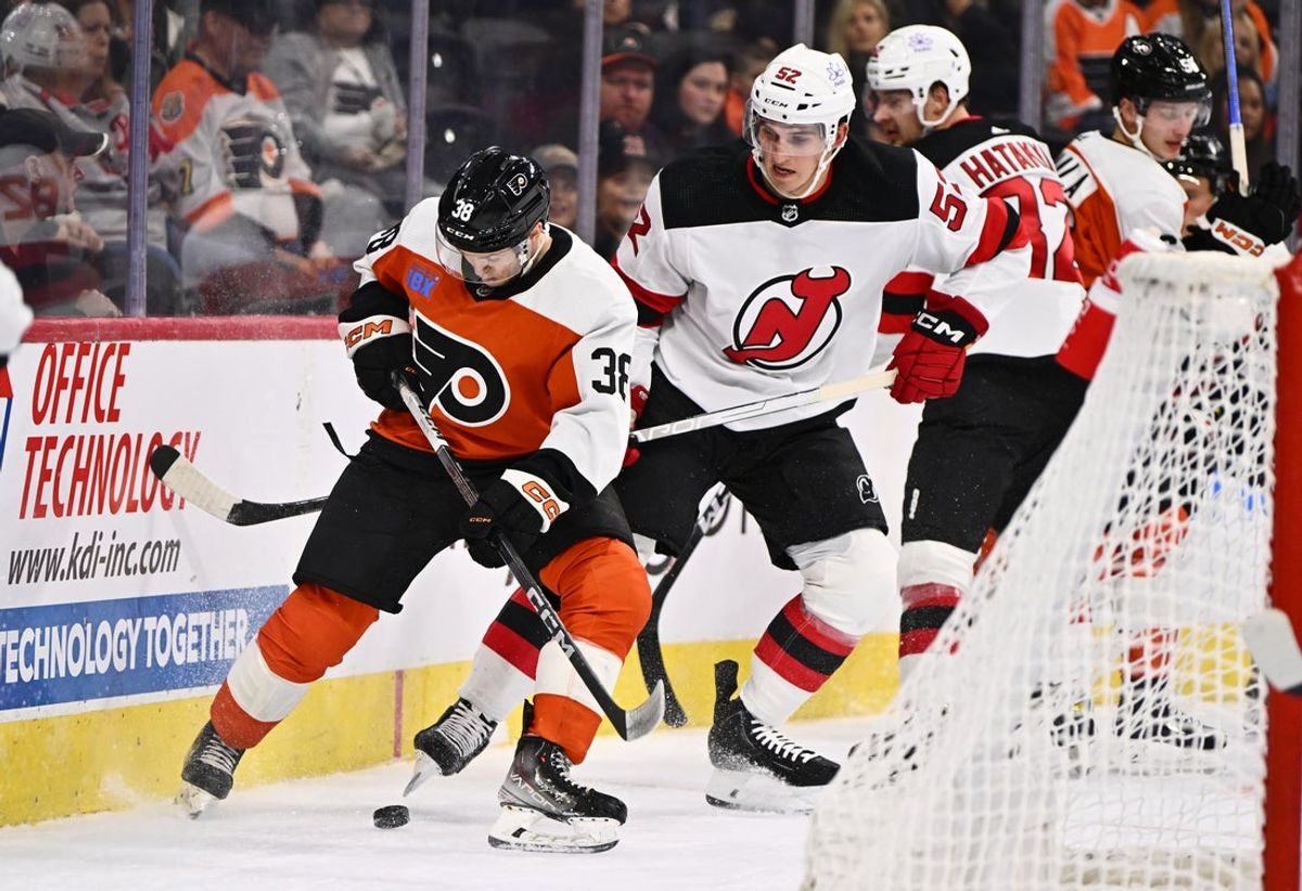 Sep 30, 2023; Philadelphia, Pennsylvania, USA; Philadelphia Flyers left wing Matt Brown (38) shields the puck from New Jersey Devils defenseman Cal Foote (52) in the second period at Wells Fargo Center. Mandatory Credit: Kyle Ross-Imagn Images