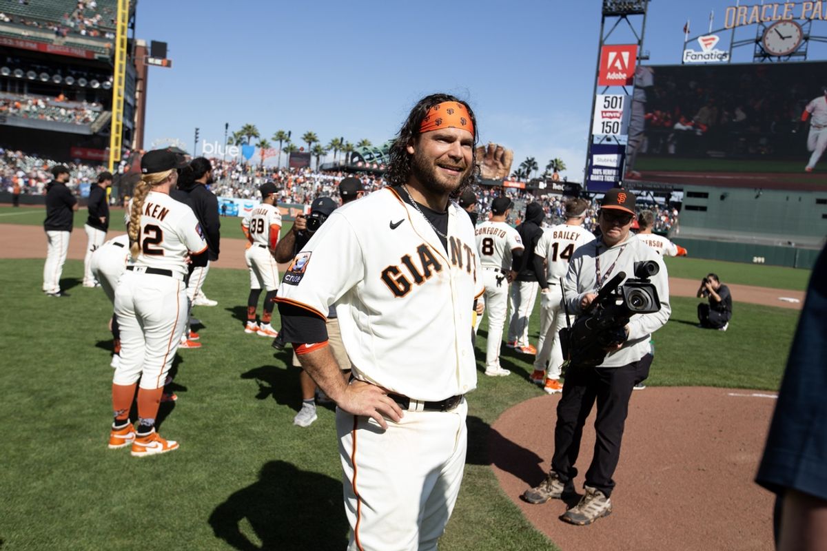 Oct 1, 2023; San Francisco, California, USA; San Francisco Giants shortstop Brandon Crawford (center) takes in the scene following the final game of the season, a 5-2 loss to the Los Angeles Dodgers, at Oracle Park. Mandatory Credit: D. Ross Cameron-Imagn Images