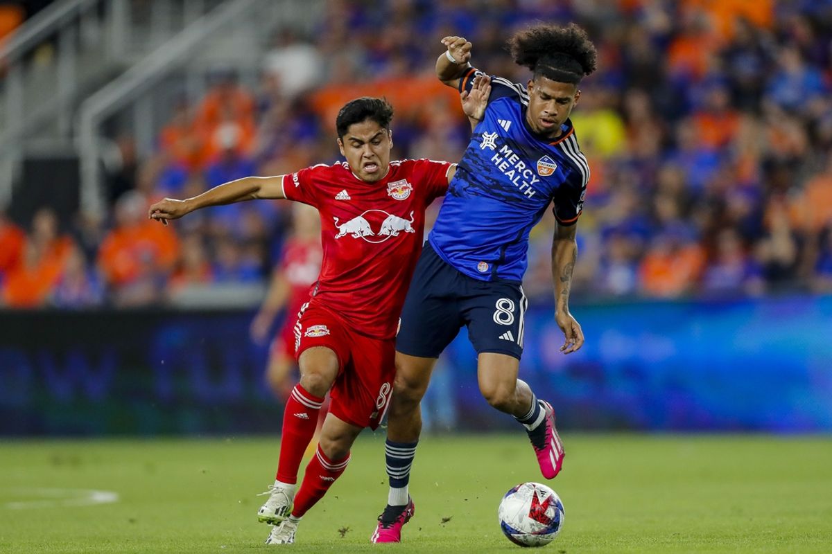 Oct 4, 2023; Cincinnati, Ohio, USA; New York Red Bulls midfielder Frankie Amaya (8) battles for the ball against FC Cincinnati midfielder Marco Angulo (8) in the first half at TQL Stadium. Mandatory Credit: Katie Stratman-Imagn Images
