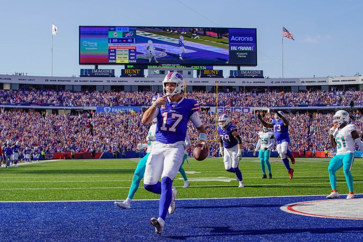Oct 1, 2023; Orchard Park, New York, USA; Buffalo Bills quarterback Josh Allen (17) runs with the ball for a touchdown against the Miami Dolphins during the second half at Highmark Stadium. Mandatory Credit: Gregory Fisher-Imagn Images
