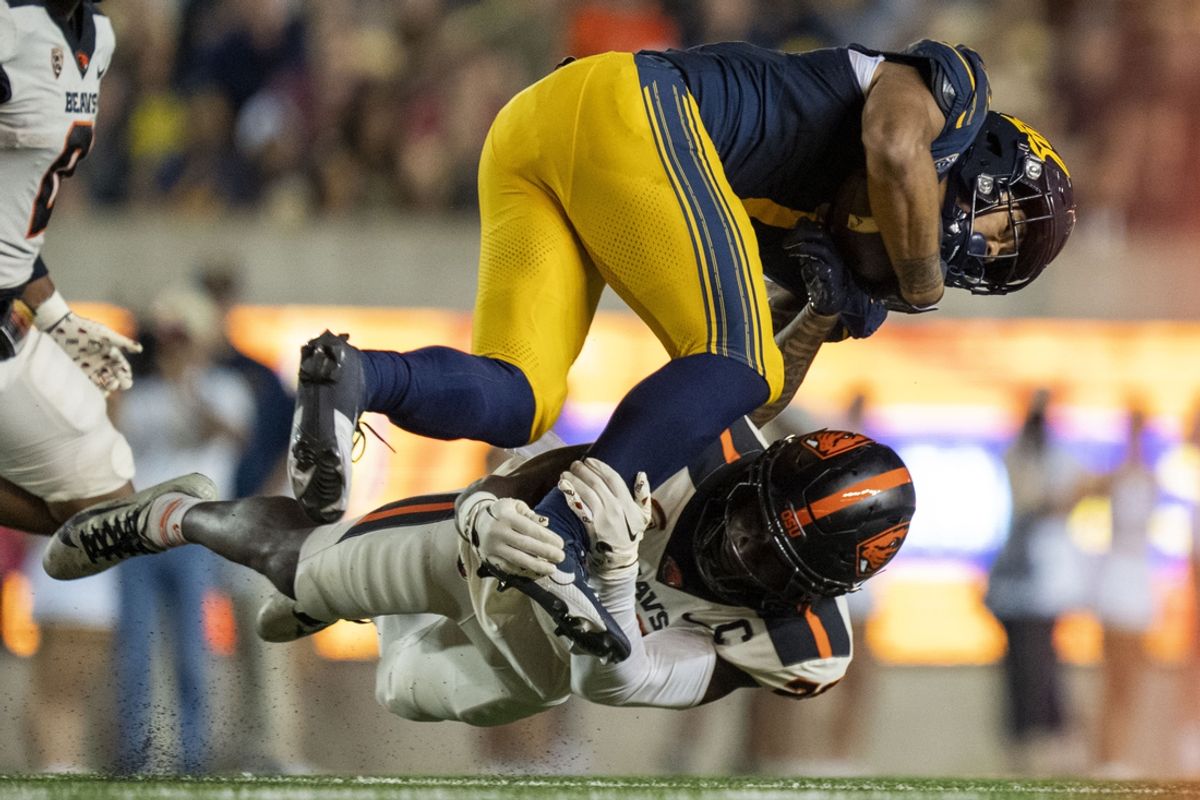 October 7, 2023; Berkeley, California, USA; California Golden Bears running back Jaydn Ott (1) is tackled by Oregon State Beavers defensive back Kitan Oladapo (28) during the second quarter at California Memorial Stadium. Mandatory Credit: Kyle Terada-Imagn Images