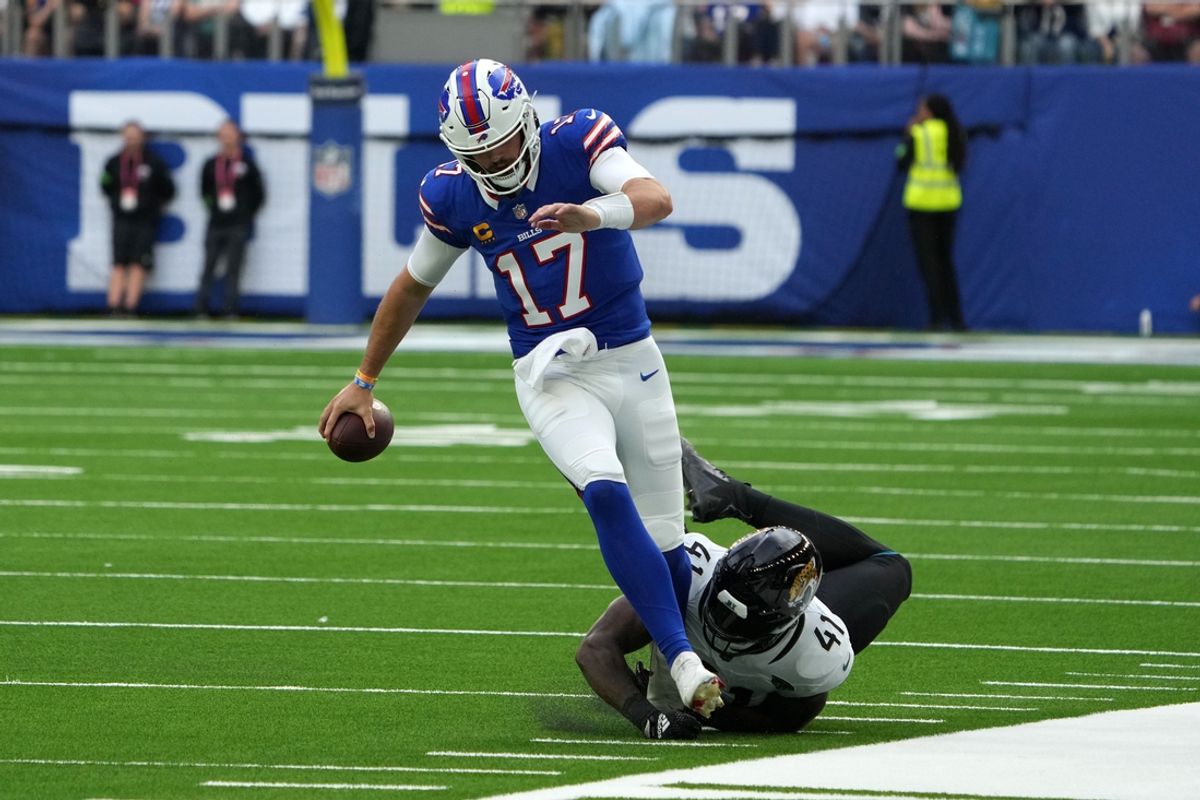 Oct 8, 2023; London United Kingdom, Buffalo Bills quarterback Josh Allen (17) carries the ball against Jacksonville Jaguars linebacker Josh Allen (41) during the first half of an NFL International Series game at Tottenham Hotspur Stadium. Mandatory Credit: Kirby Lee-Imagn Images