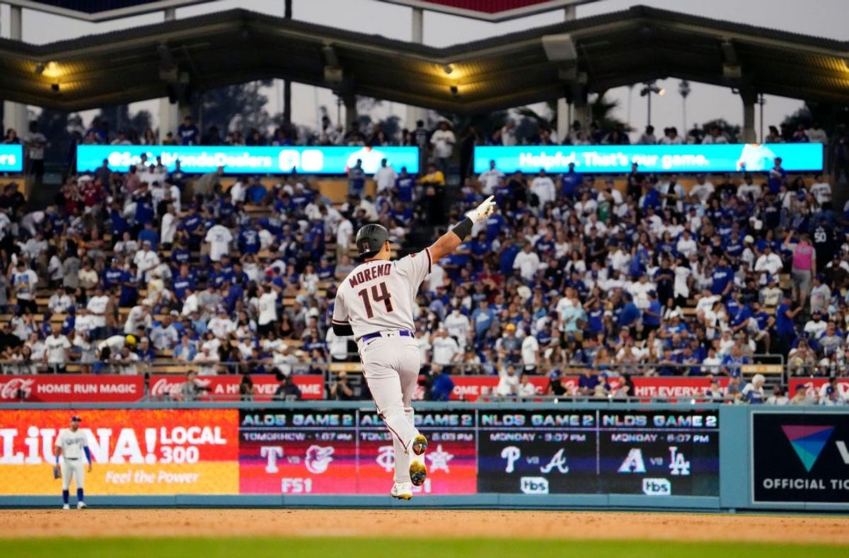 Arizona Diamondbacks Gabriel Moreno (14) reacts after hitting a three-run home run off Los Angeles Dodgers starting pitcher Clayton Kershaw in the first inning during Game 1 of the NLDS at Dodger Stadium in Los Angeles on Oct. 7, 2023.