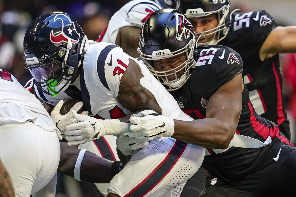 Oct 8, 2023; Atlanta, Georgia, USA; Atlanta Falcons defensive tackle Calais Campbell (93) tackles Houston Texans running back Dameon Pierce (31) during the first quarter at Mercedes-Benz Stadium. Mandatory Credit: Dale Zanine-USA TODAY Sports