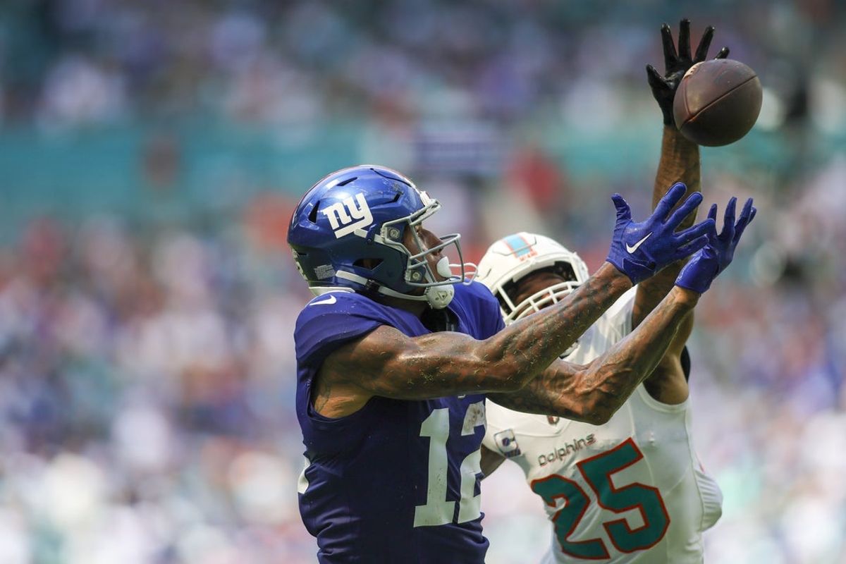 Oct 8, 2023; Miami Gardens, Florida, USA; New York Giants tight end Darren Waller (12) reaches for the football but cannot make a catch against Miami Dolphins cornerback Xavien Howard (25) during the second quarter at Hard Rock Stadium. Mandatory Credit: Sam Navarro-Imagn Images