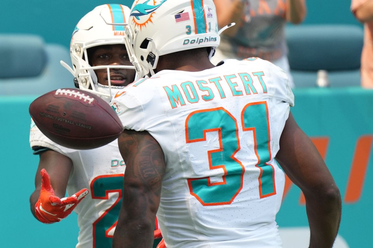 Miami Dolphins running back De'Von Achane (28) celebrates a touchdown with Miami Dolphins running back Raheem Mostert (31) against the New York Giants during the first half of an NFL game at Hard Rock Stadium in Miami Gardens, October 8, 2023.