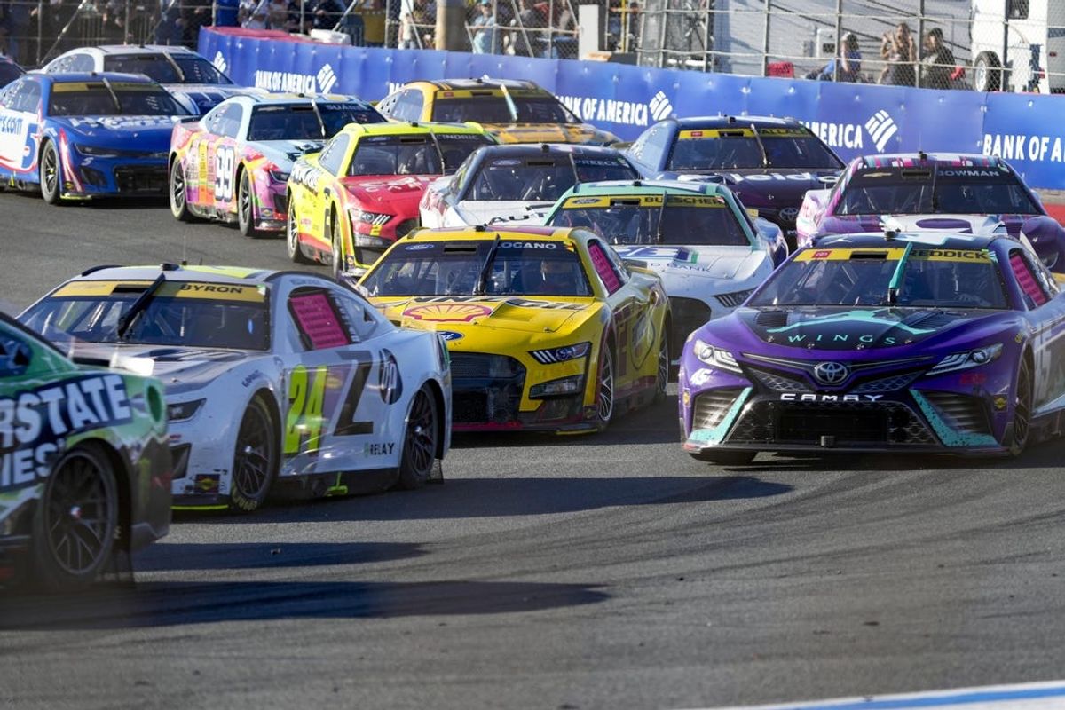 Oct 8, 2023; Concord, North Carolina, USA; Cars crowd into turn four after a restart during the Bank of America Roval 400 at Charlotte Motor Speedway Road Course. Mandatory Credit: Jim Dedmon-USA TODAY Sports