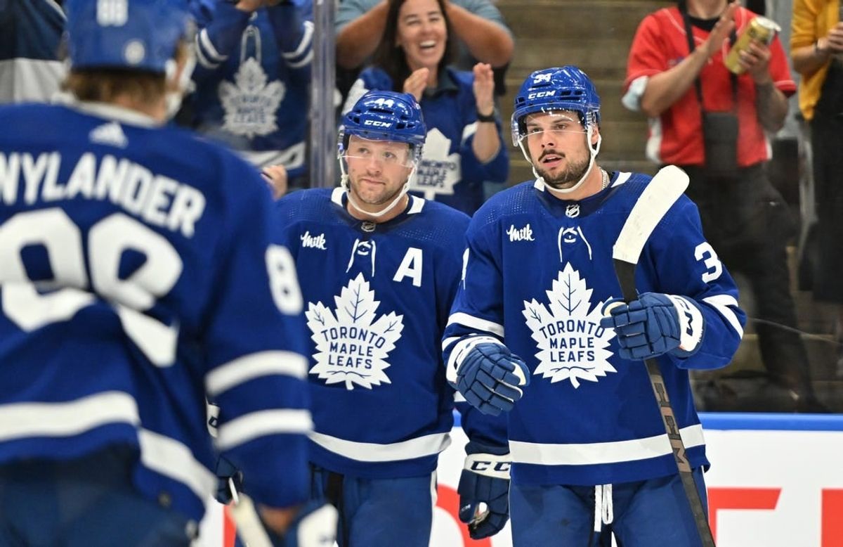 Oct 5, 2023; Toronto, Ontario, CAN; Toronto Maple Leafs forward Auston Matthews (34) celebrates with defenseman Morgan Rielly (44) and forward William Nylander (88) after scoring a goal against the Detroit Red Wings in the first period at Scotiabank Arena.