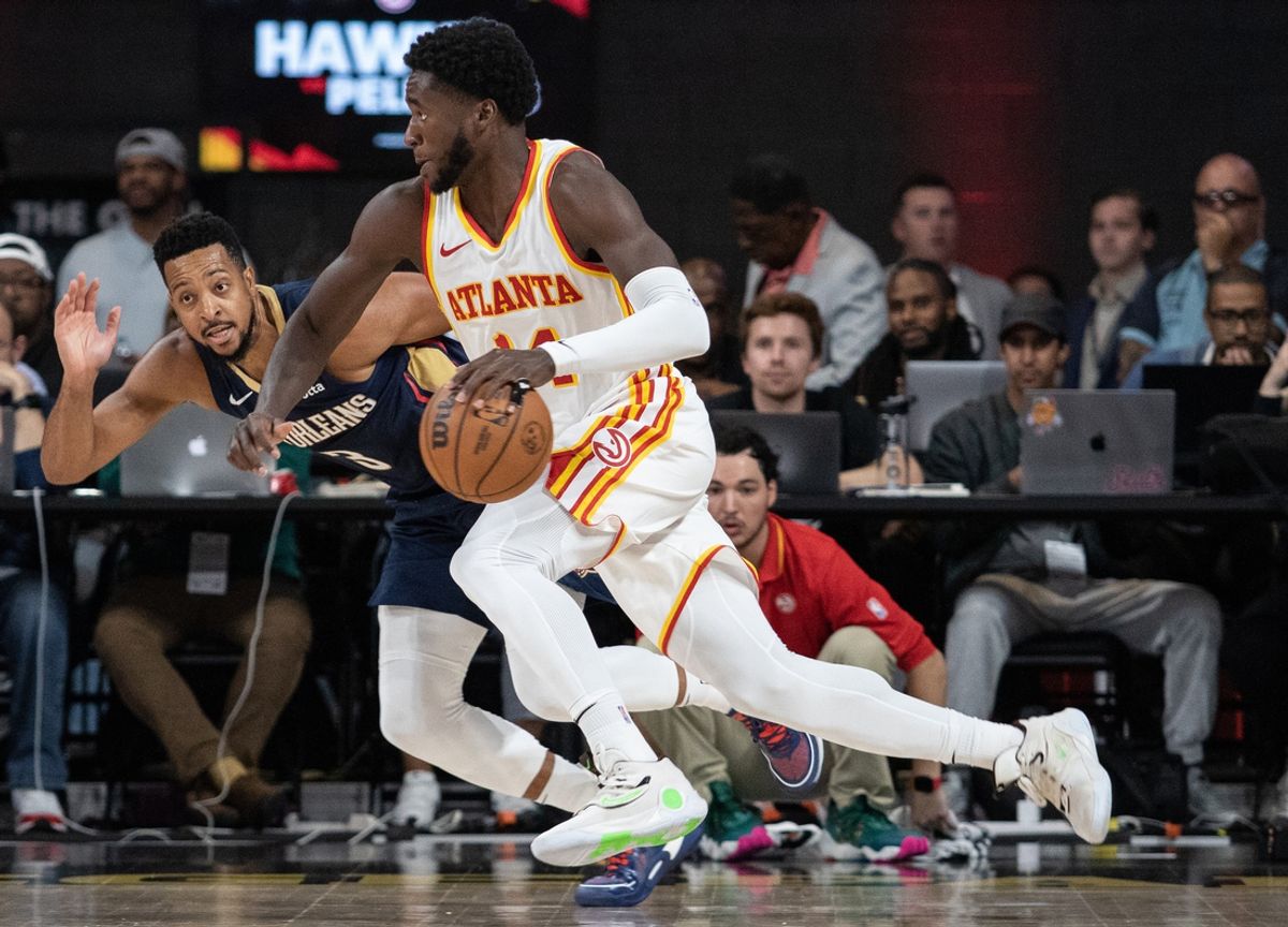 Oct 14, 2023; College Park, Georgia, USA; Atlanta Hawks forward AJ Griffin (14) drives the ball against New Orleans Pelicans guard CJ McCollum (3) during the third quarter at Gateway Center Arena at College Park. Mandatory Credit: Jordan Godfree-Imagn Images