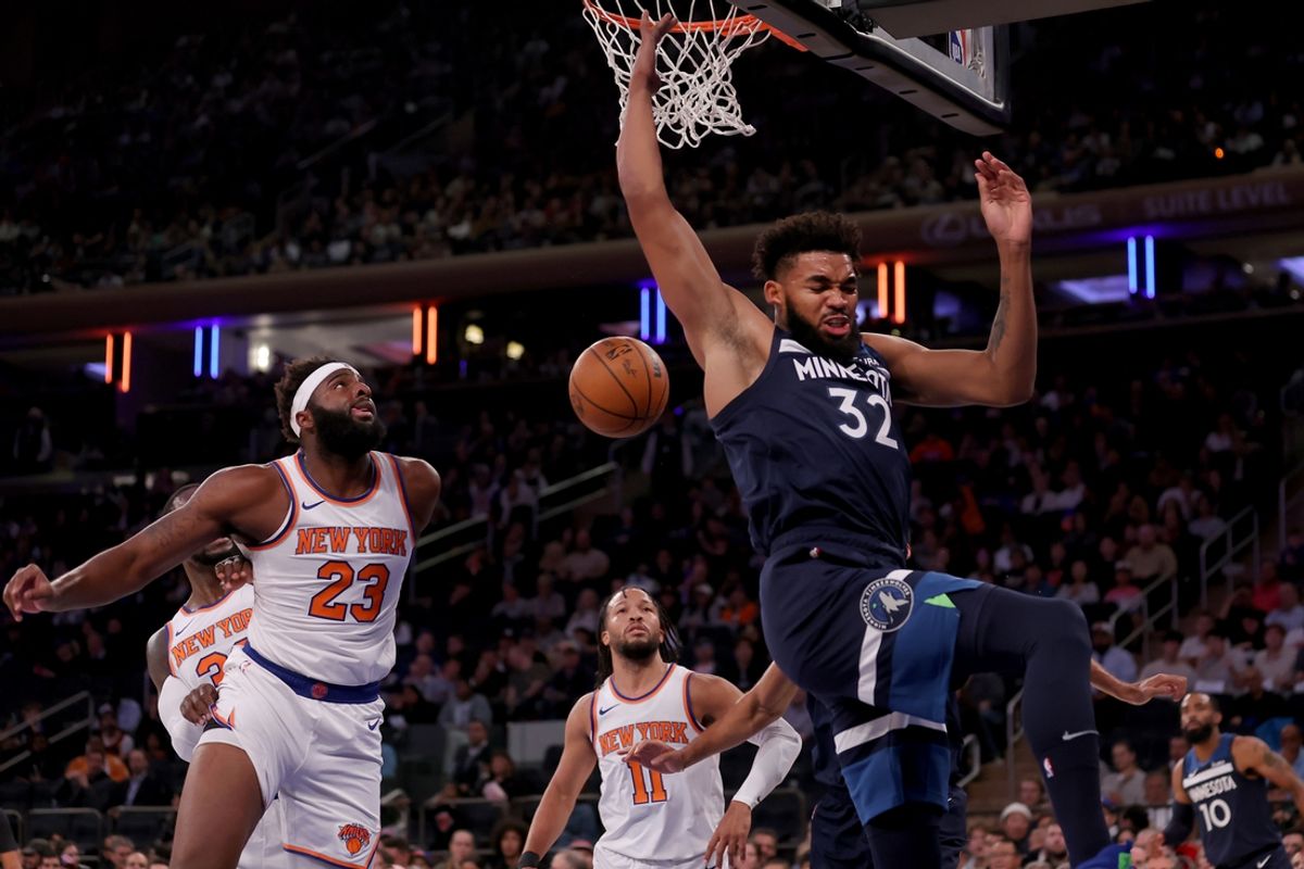 Oct 14, 2023; New York, New York, USA; Minnesota Timberwolves center Karl-Anthony Towns (32) reacts after a dunk against New York Knicks center Mitchell Robinson (23) and guard Jalen Brunson (11) during the first quarter at Madison Square Garden. Mandatory Credit: Brad Penner-Imagn Images