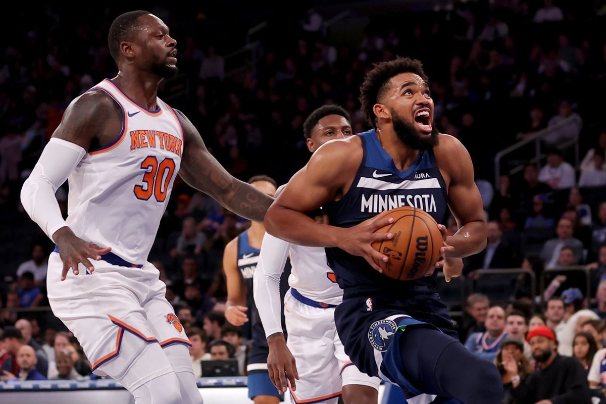 Oct 14, 2023; New York, New York, USA; Minnesota Timberwolves center Karl-Anthony Towns (32) drives to the basket against New York Knicks forward Julius Randle (30) and guard RJ Barrett (9) during the first quarter at Madison Square Garden. Mandatory Credit: Brad Penner-Imagn Images
