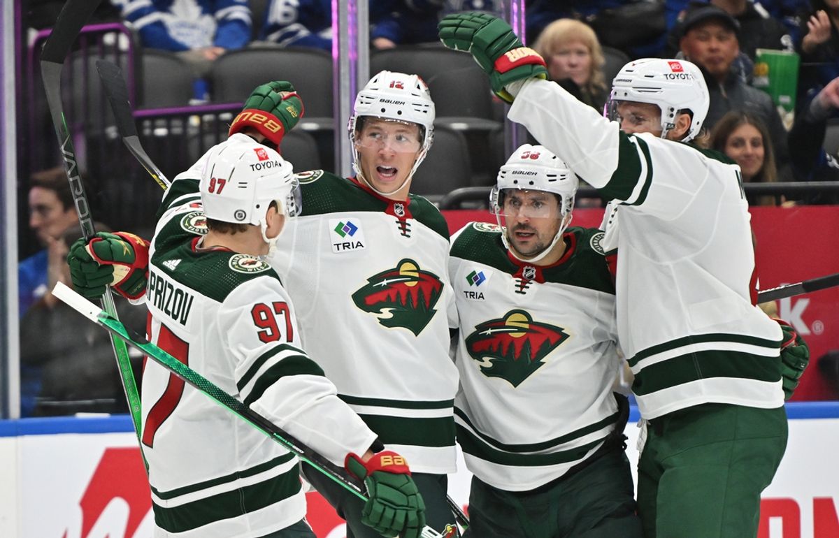 Oct 14, 2023; Toronto, Ontario, CAN;   Minnesota Wild forward Matt Boldy (12) celebrates with forward Mats Zuccarello (36) and Kirill Kaprizov (97) and defenseman Jon Merrill (4) after scoring a goal against the Toronto Maple Leafs in the second period at Scotiabank Arena. Mandatory Credit: Dan Hamilton-Imagn Images