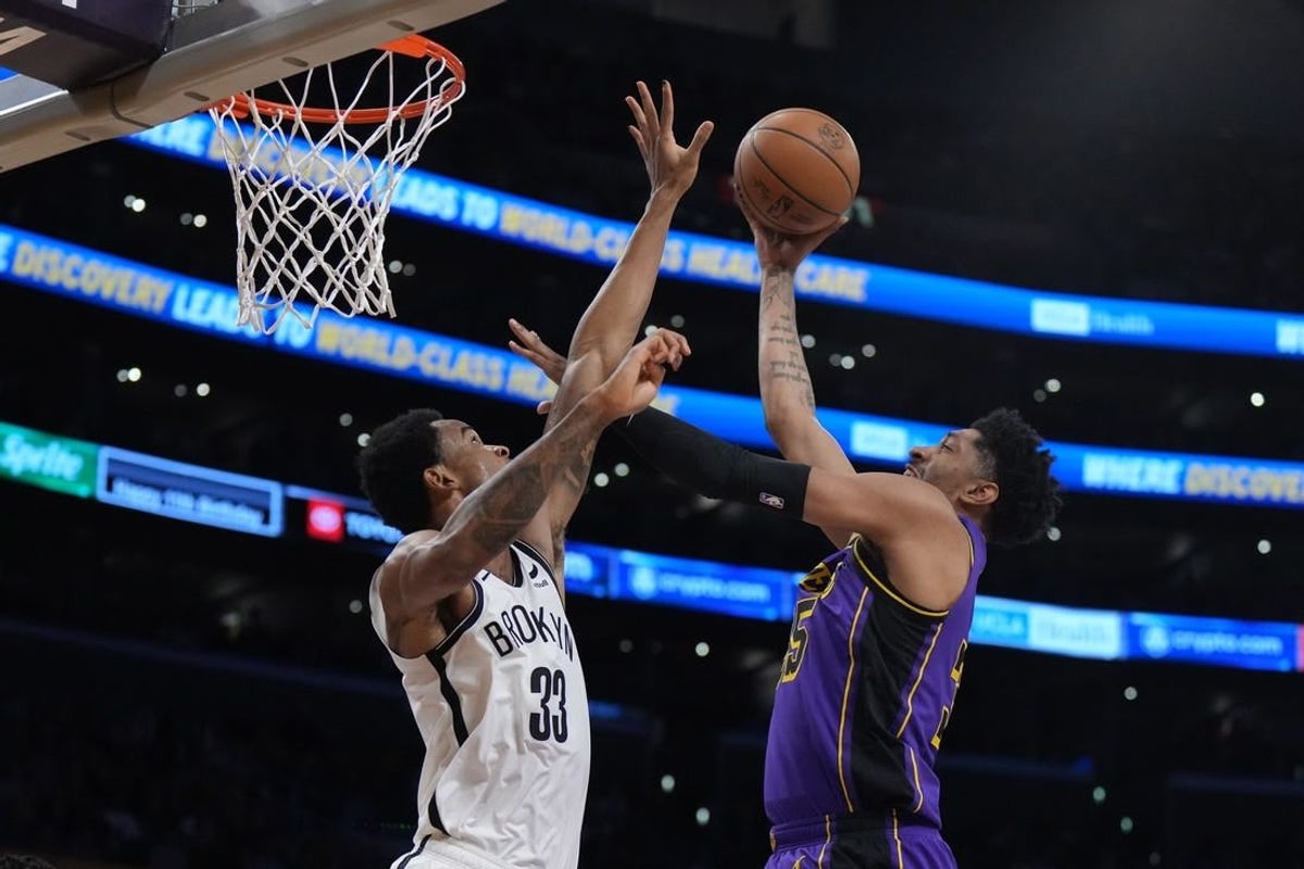 Jan 19, 2024; Los Angeles, California, USA; Los Angeles Lakers forward Christian Wood (35) shoots the ball against Brooklyn Nets center Nic Claxton (33) in the first half at Crypto.com Arena.