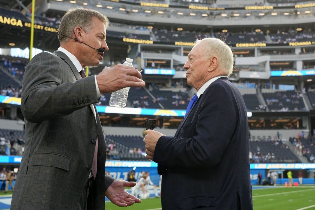Oct 16, 2023; Inglewood, California, USA; Dallas Cowboys owner Jerry Jones (right) talks with former quarterback Troy Aikman before the game against the Los Angeles Chargers at SoFi Stadium. Mandatory Credit: Kirby Lee-Imagn Images