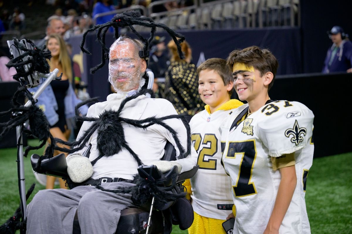 Oct 19, 2023; New Orleans, Louisiana, USA; Former New Orleans Saints player Steve Gleason wears a halloween costume before a game between the New Orleans Saints and the Jacksonville Jaguars at the Caesars Superdome. Because Gleason uses a breathing tube he can be wrapped with cellophane covering his mouth. Mandatory Credit: Matthew Hinton-Imagn Images
