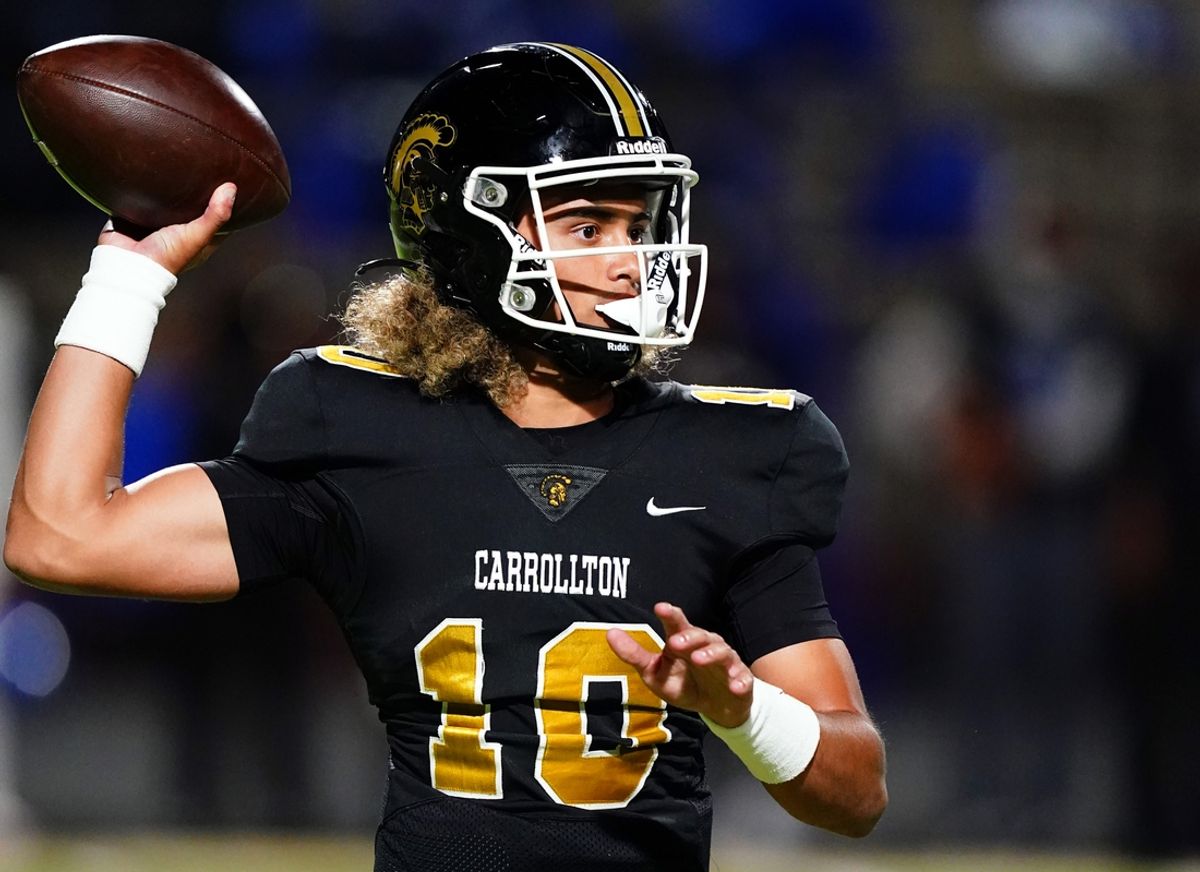 Oct 20, 2023; Carrollton, GA, USA; Carrollton Trojans quarterback Julian Lewis (10) drops back to pass against the Westlake Lions during the first half at Grisham Stadium. The 15-year-old Carrollton High student has already committed to playing for the University of Southern California Trojans and has been considered one of the top high school quarterback prospects. Mandatory Credit: John David Mercer-Imagn Images