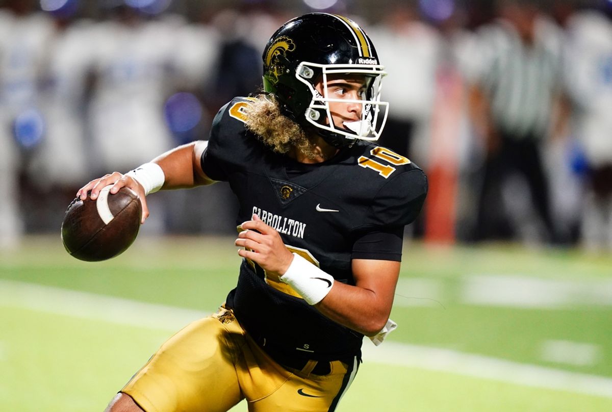 Oct 20, 2023; Carrollton, GA, USA; Carrollton Trojans quarterback Julian Lewis (10) scrambles out of the pocket against the Westlake Lions during the first half at Grisham Stadium. The 15-year-old Carrollton High student has already committed to playing for the University of Southern California Trojans and has been considered one of the top high school quarterback prospects. Mandatory Credit: John David Mercer-Imagn Images