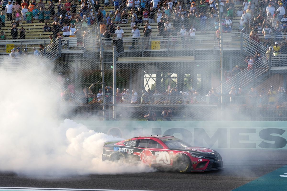 Oct 22, 2023; Homestead, Florida, USA; NASCAR Cup Series driver Christopher Bell (20) celebrates with a burnout after winning the 4EVER 400 presented by Mobil 1 at Homestead-Miami Speedway. Mandatory Credit: Jasen Vinlove-Imagn Images
