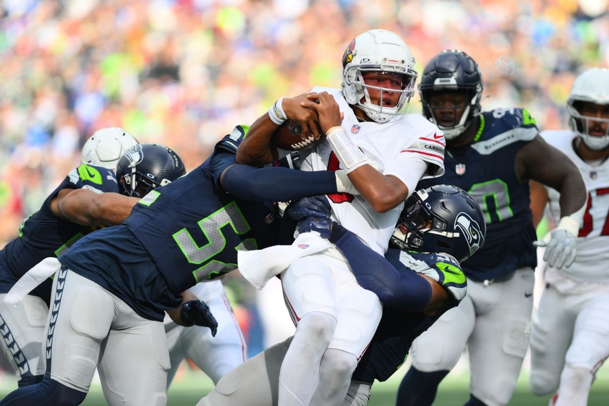 Oct 22, 2023; Seattle, Washington, USA; Seattle Seahawks linebacker Darrell Taylor (52) and linebacker Jordyn Brooks (56) tackle Arizona Cardinals quarterback Joshua Dobbs (9) during the second half at Lumen Field. Mandatory Credit: Steven Bisig-USA TODAY Sports