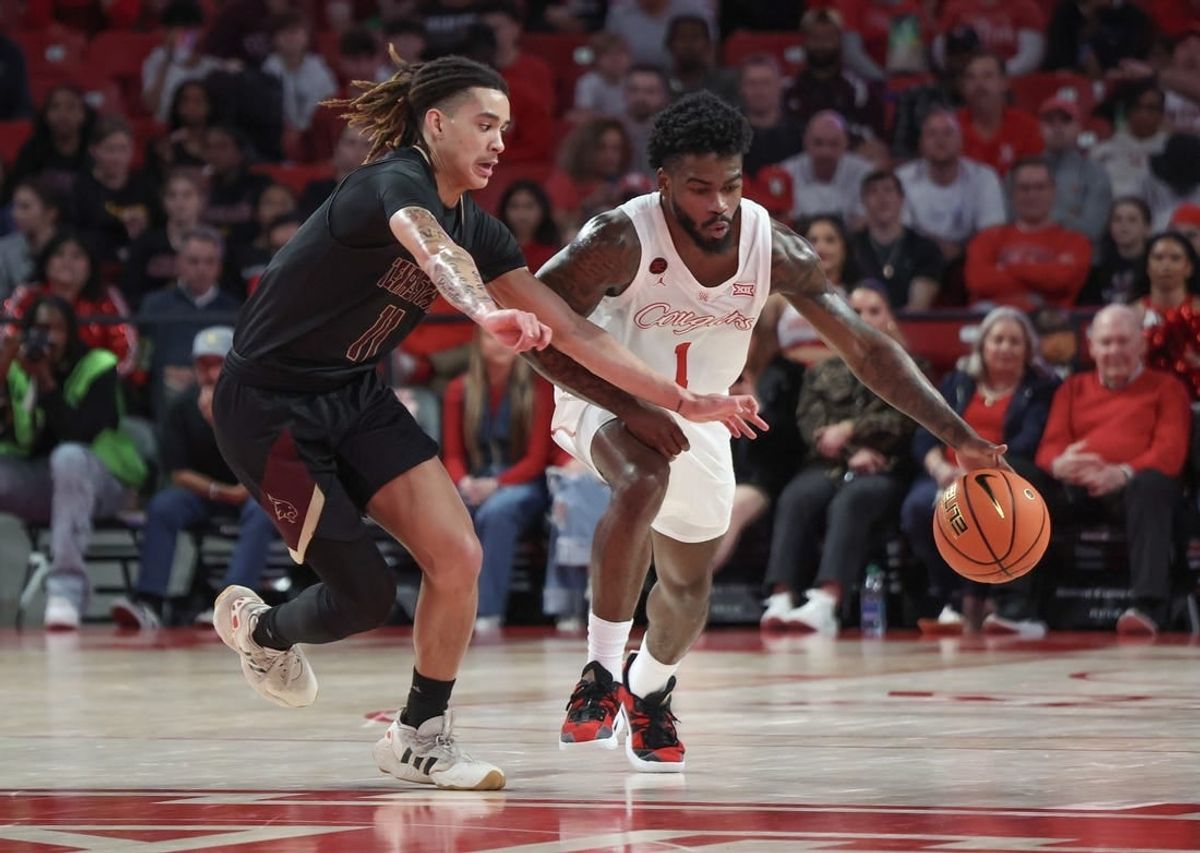 Dec 21, 2023; Houston, Texas, USA; Houston Cougars guard Jamal Shead (1) dribbles against Texas State Bobcats guard Kaden Gumbs (11) in the second half at Fertitta Center.