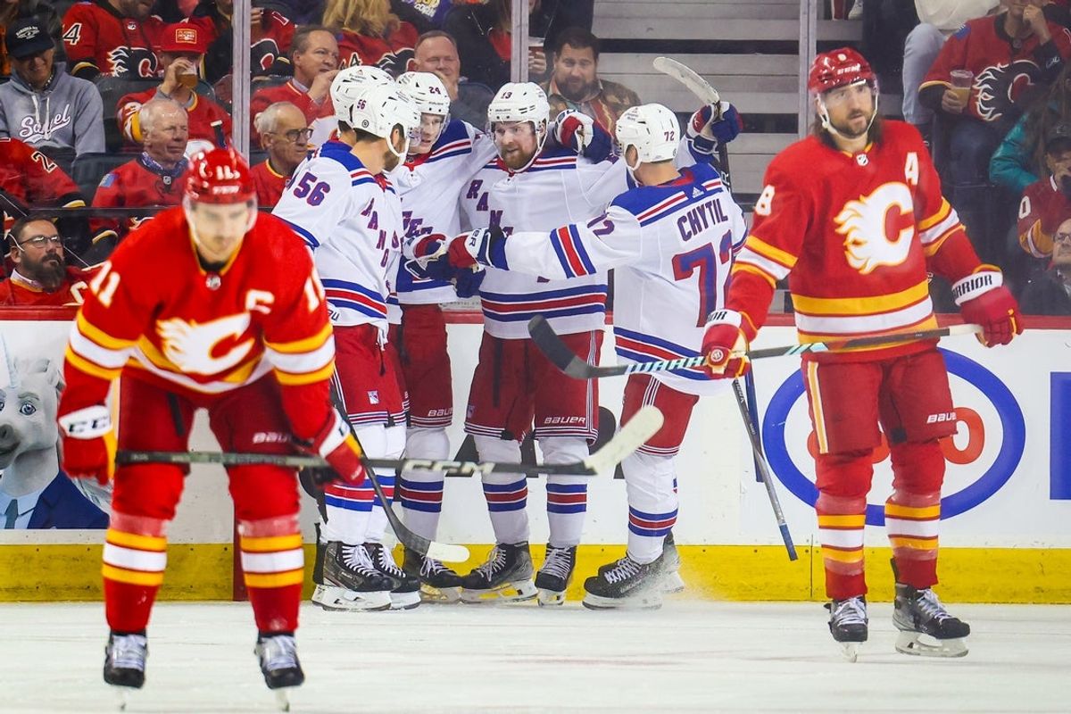 Oct 24, 2023; Calgary, Alberta, CAN; New York Rangers left wing Alexis Lafreniere (13) celebrates his goal with teammates against the Calgary Flames during the second period at Scotiabank Saddledome. Mandatory Credit: Sergei Belski-Imagn Images