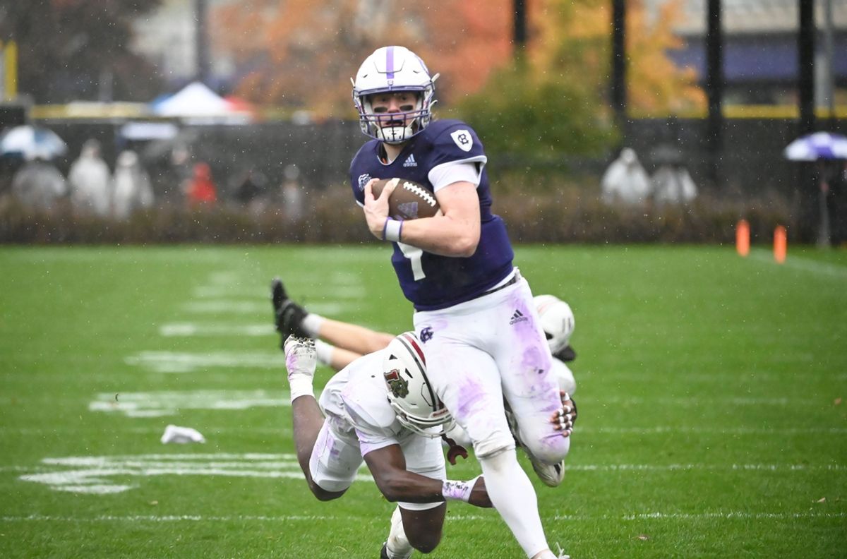 Quarterback Matt Sluka (9) dodges Lafayette defenders while scoring a touchdown for Holy Cross.