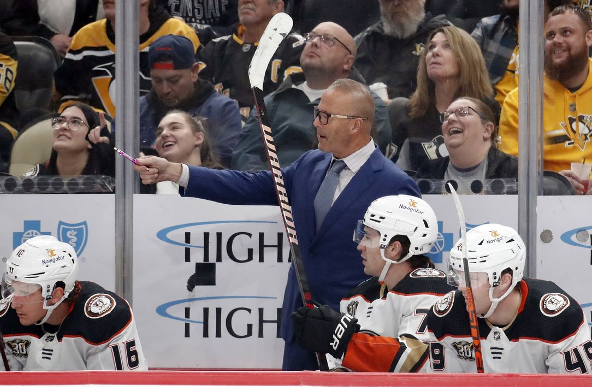 Oct 30, 2023; Pittsburgh, Pennsylvania, USA;  Anaheim Ducks head coach Greg Cronin (rear) gestures on the bench against the Pittsburgh Penguins during the first period at PPG Paints Arena. Mandatory Credit: Charles LeClaire-Imagn Images