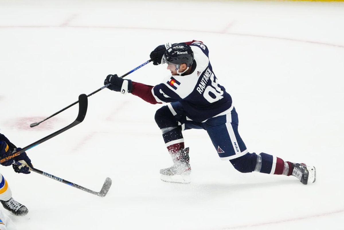 Nov 1, 2023; Denver, Colorado, USA; Colorado Avalanche left wing Gabriel Landeskog (92) shoots the puck in the third period against the St. Louis Blues at Ball Arena. Mandatory Credit: Ron Chenoy-Imagn Images